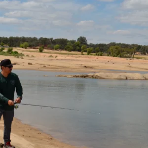 Angler fishing with the EdgeWalker 66MHT travel rod at the lakeshore
